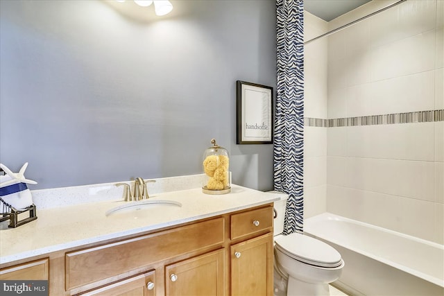 full bathroom featuring toilet, tiled shower / bath combo, and vanity