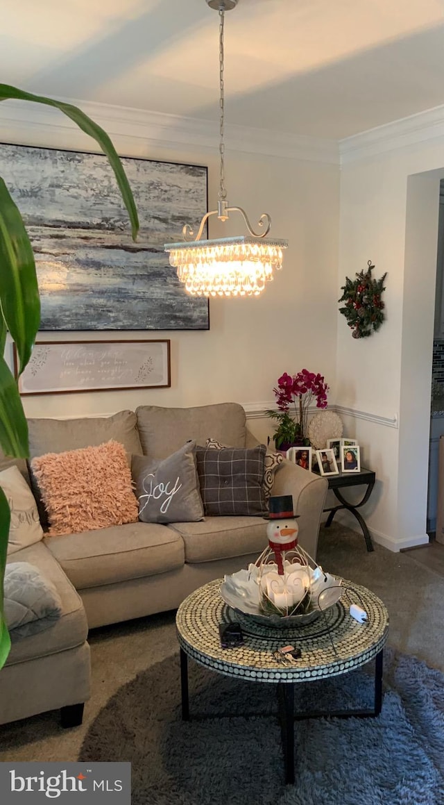 living room featuring crown molding, a notable chandelier, and dark colored carpet