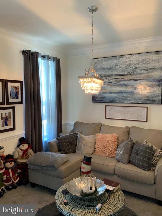 carpeted living room featuring ornamental molding and a notable chandelier