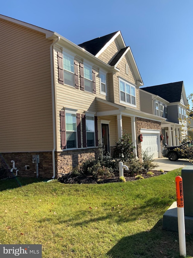 view of front of home with a front yard and a garage