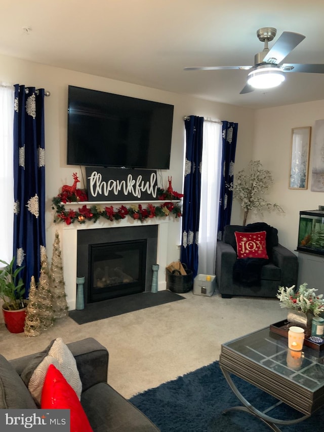 carpeted living room featuring ceiling fan