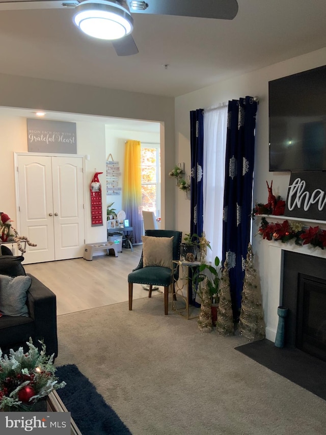 living room featuring light carpet and ceiling fan