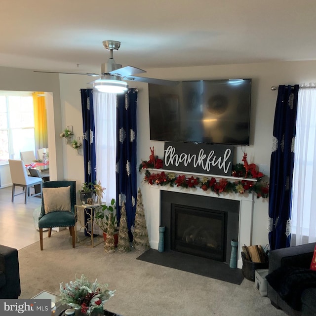 carpeted living room featuring ceiling fan