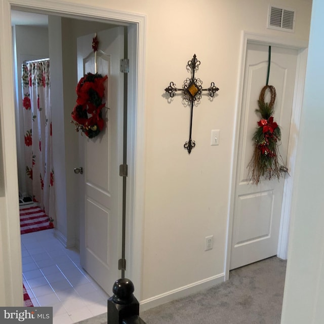 corridor featuring light tile floors