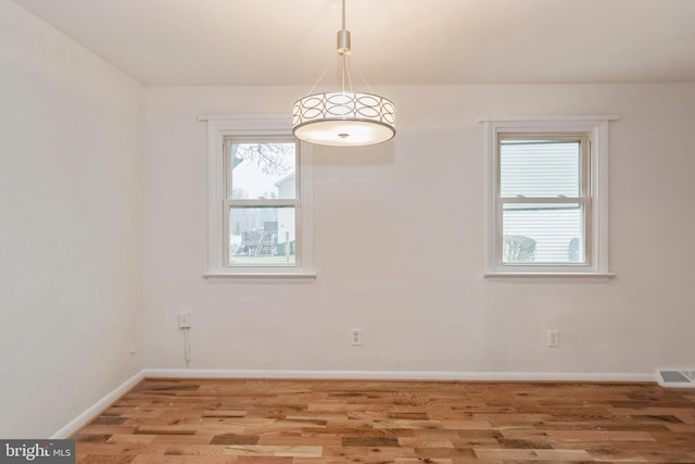 spare room featuring hardwood / wood-style floors