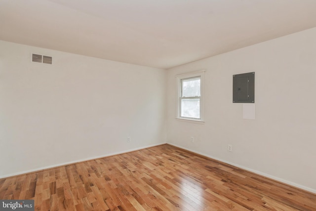 empty room featuring light hardwood / wood-style floors and electric panel