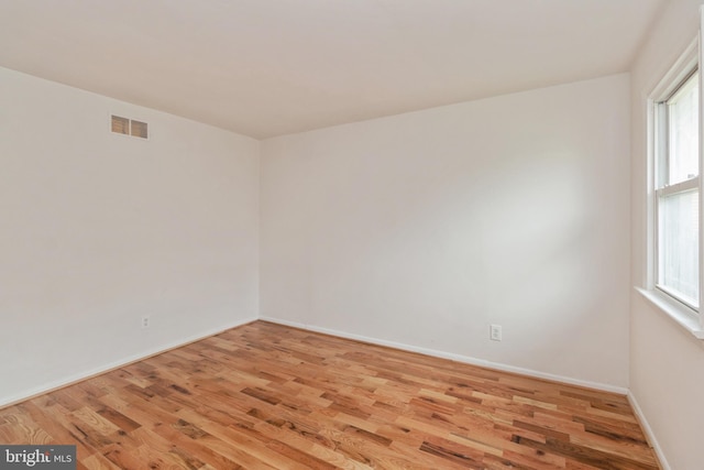 unfurnished room featuring light hardwood / wood-style flooring and a wealth of natural light