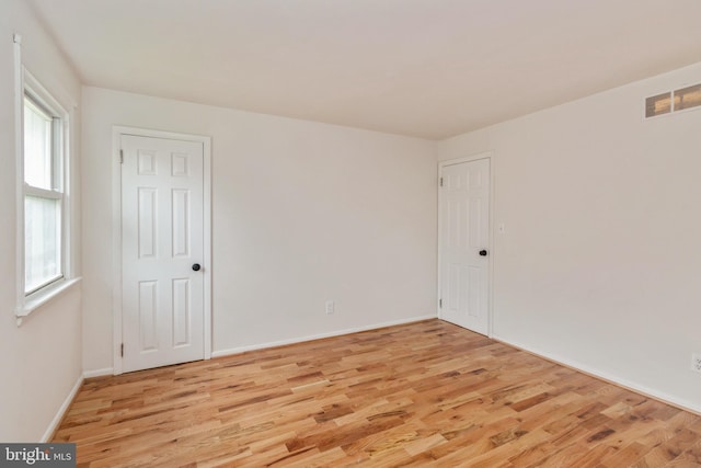 spare room featuring light hardwood / wood-style floors