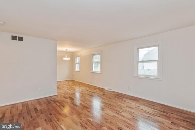 spare room with light wood-type flooring