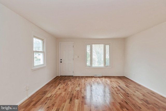 unfurnished room with light hardwood / wood-style floors