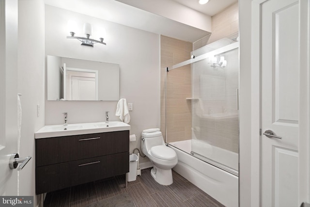 full bathroom featuring vanity, toilet, enclosed tub / shower combo, and tile floors