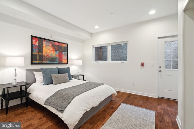 bedroom with dark hardwood / wood-style floors