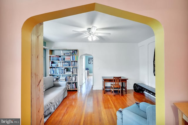 living room with ceiling fan and light hardwood / wood-style flooring