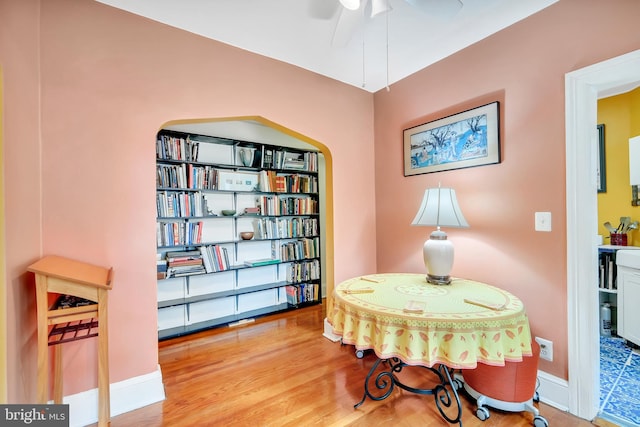 living area with ceiling fan and light wood-type flooring