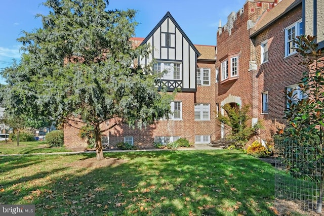 tudor home with a front yard