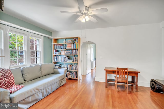 living room featuring ceiling fan and light wood-type flooring