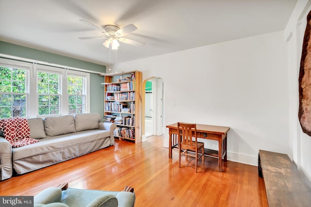 living room featuring ceiling fan and light hardwood / wood-style flooring