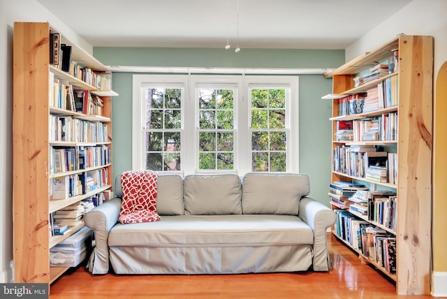 sitting room featuring hardwood / wood-style flooring and a healthy amount of sunlight