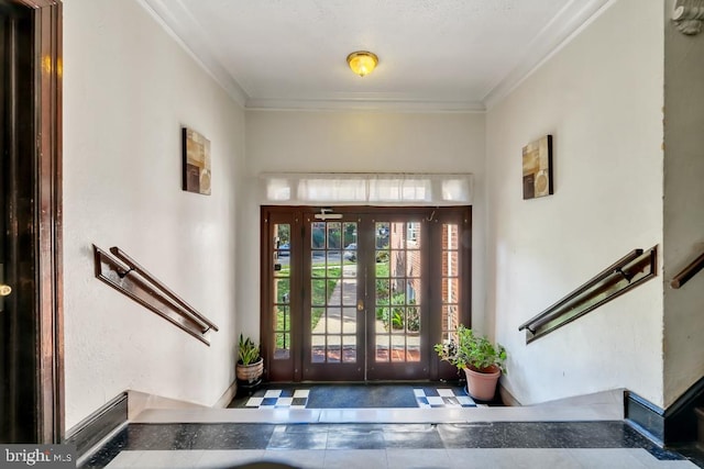 entryway with crown molding and french doors