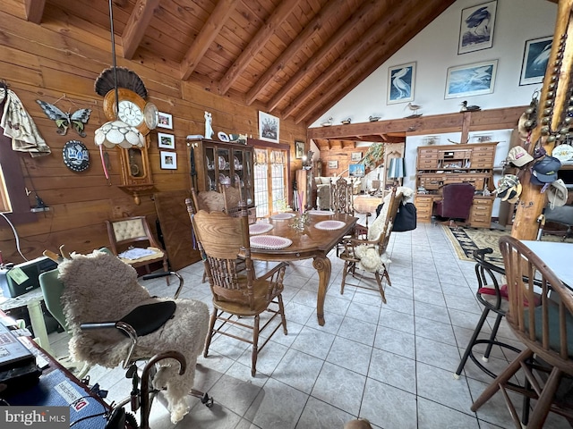 dining area with wood walls, wooden ceiling, high vaulted ceiling, light tile patterned floors, and beamed ceiling