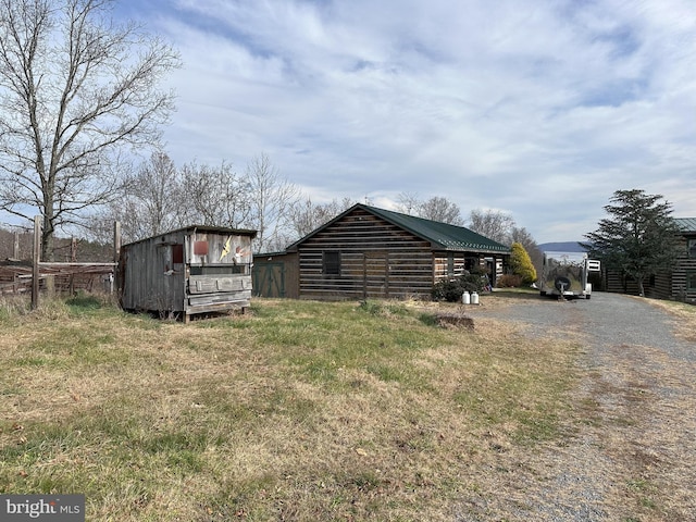 view of side of property with an outbuilding