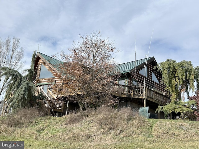 back of house with a deck