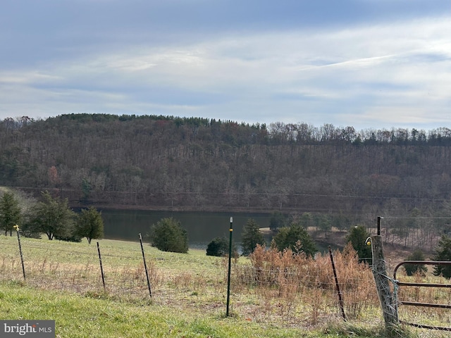 property view of mountains featuring a rural view and a water view