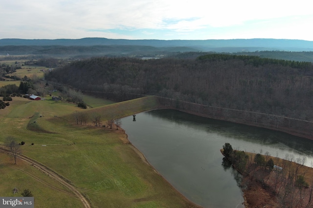 drone / aerial view featuring a water and mountain view