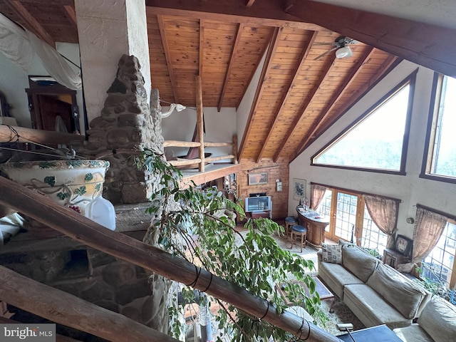 living room featuring vaulted ceiling with beams, ceiling fan, and wooden ceiling