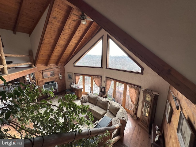 living room with hardwood / wood-style floors, ceiling fan, wooden ceiling, and beam ceiling