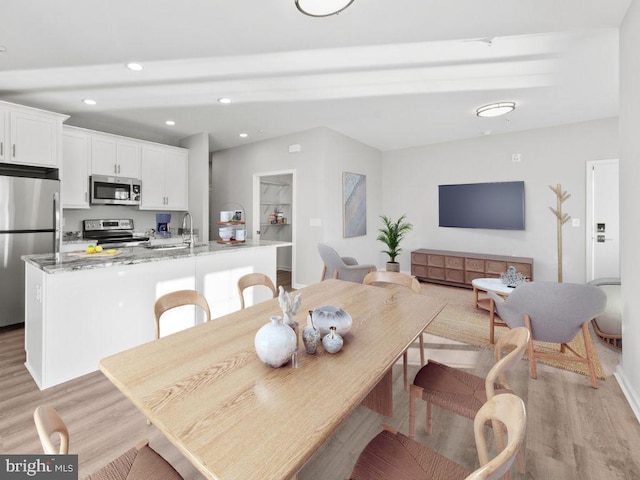 dining room with light hardwood / wood-style floors and sink