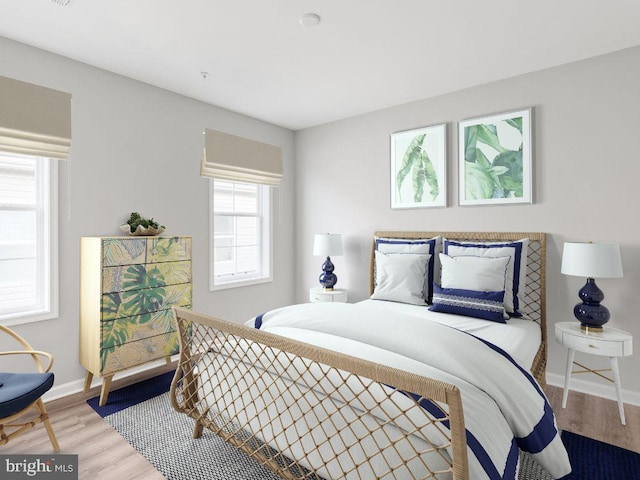 bedroom featuring wood-type flooring and multiple windows