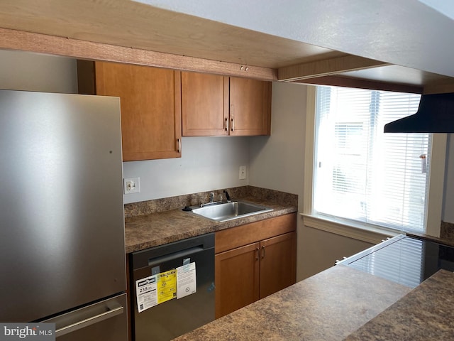 kitchen featuring dishwasher, stainless steel fridge, and sink