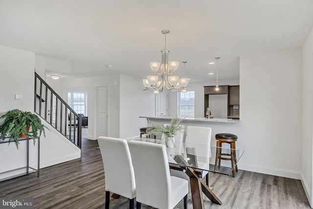 dining space featuring an inviting chandelier and wood-type flooring