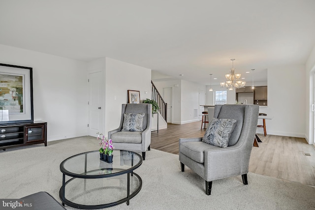 carpeted living room with a notable chandelier