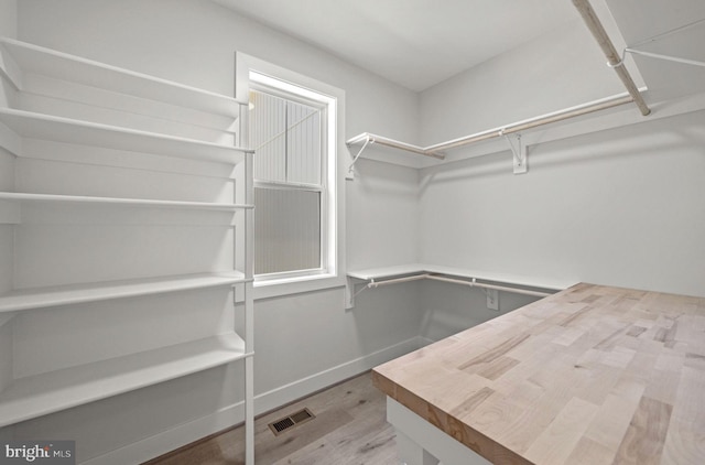 spacious closet featuring light hardwood / wood-style flooring