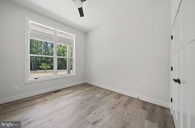 unfurnished room with ceiling fan and light wood-type flooring