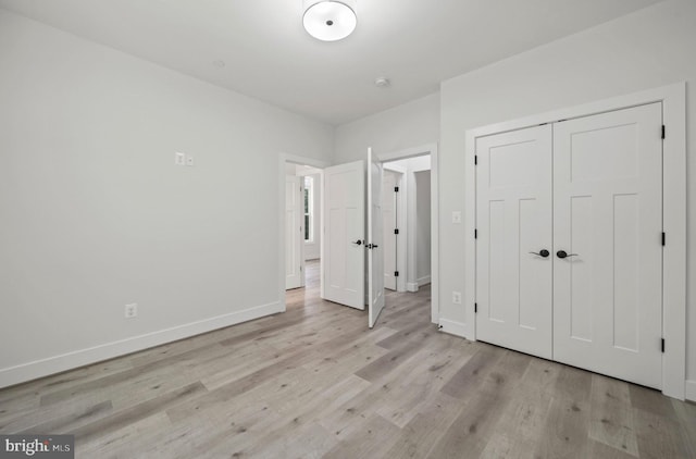 unfurnished bedroom with light hardwood / wood-style floors and a closet