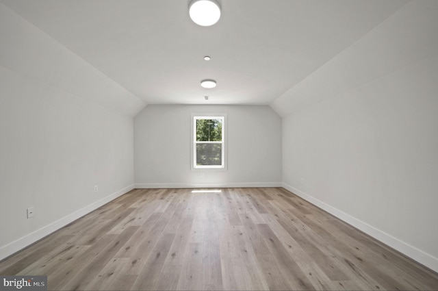 bonus room with lofted ceiling and light hardwood / wood-style floors