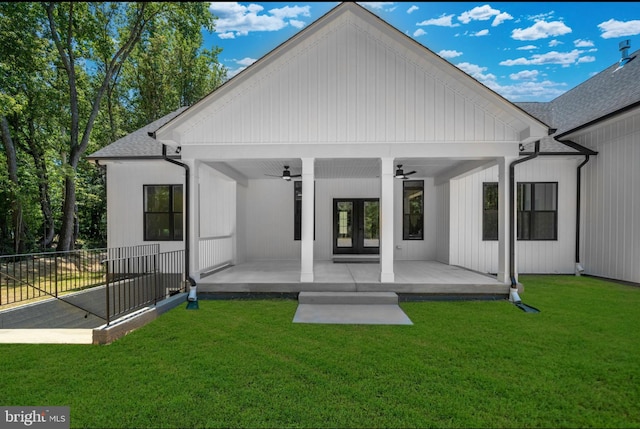 back of property featuring a yard and ceiling fan