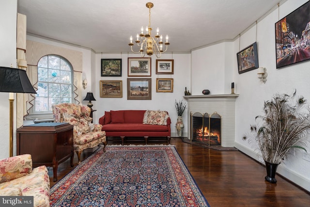 living room with a brick fireplace, a notable chandelier, dark hardwood / wood-style floors, and a textured ceiling