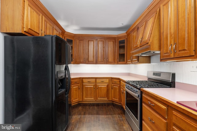 kitchen featuring black fridge with ice dispenser, premium range hood, dark wood-type flooring, and stainless steel gas range oven