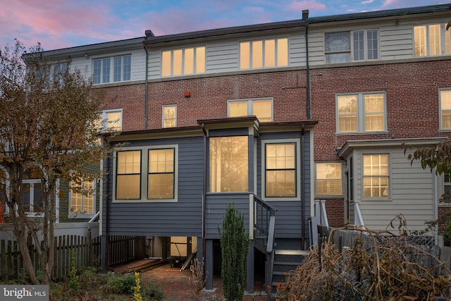 view of back house at dusk