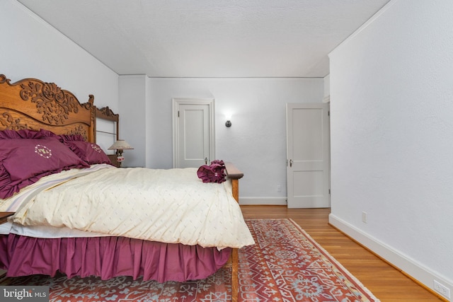 bedroom with hardwood / wood-style flooring