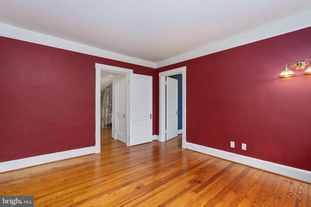 unfurnished room with wood-type flooring