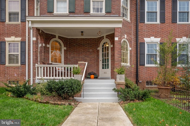 entrance to property featuring a porch