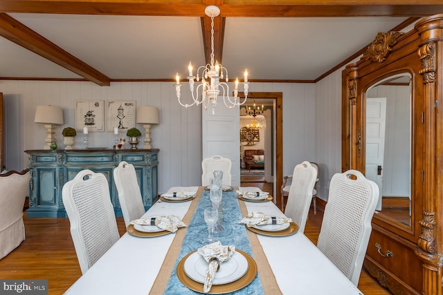 dining area featuring ornamental molding, beam ceiling, wood-type flooring, a chandelier, and wood walls