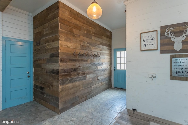 hall featuring wood walls and ornamental molding