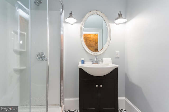 bathroom featuring vanity and a shower with shower door