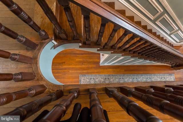 stairway featuring wood walls